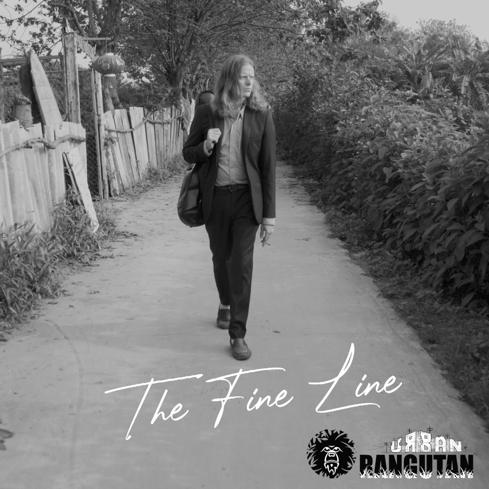Man walking along a path with his guitar slung over one shoulder - cover art for single The Fine Line by Urban Orangutan